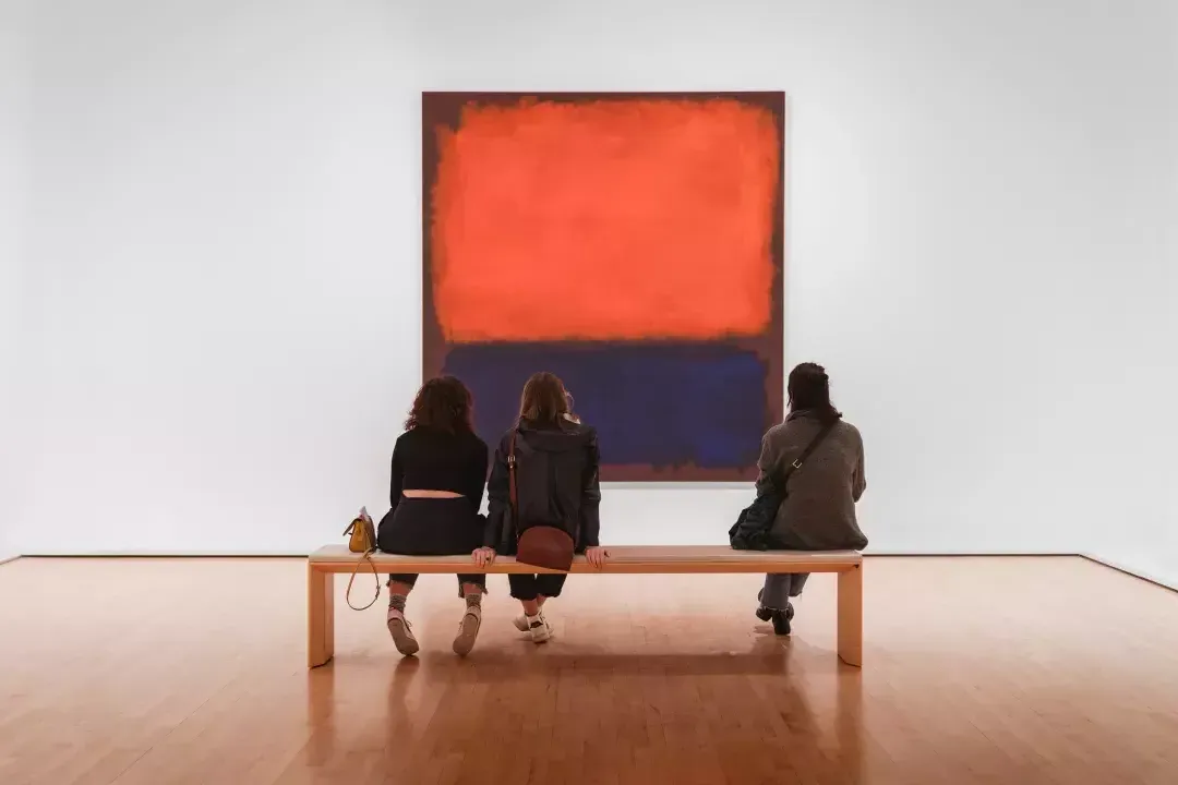 Museum patrons looking at Rothko painting on a bench